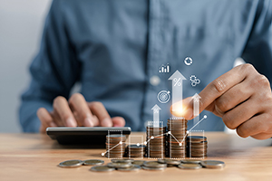 Businessman stacking money coins accounting for increase financi